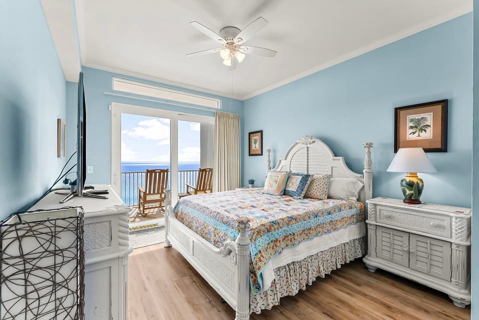 Cozy bedroom with ocean views and a balcony seating area