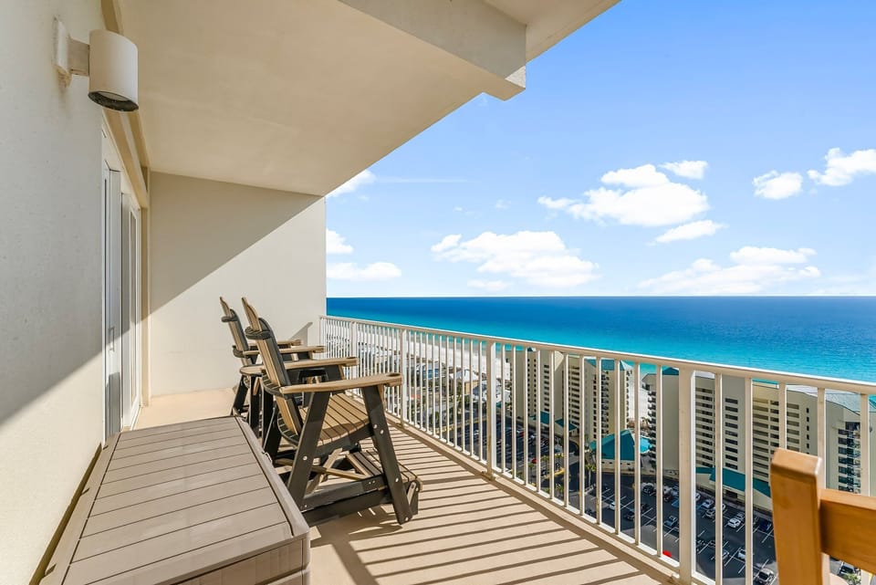 Relax on the balcony with ocean views and comfortable seating.