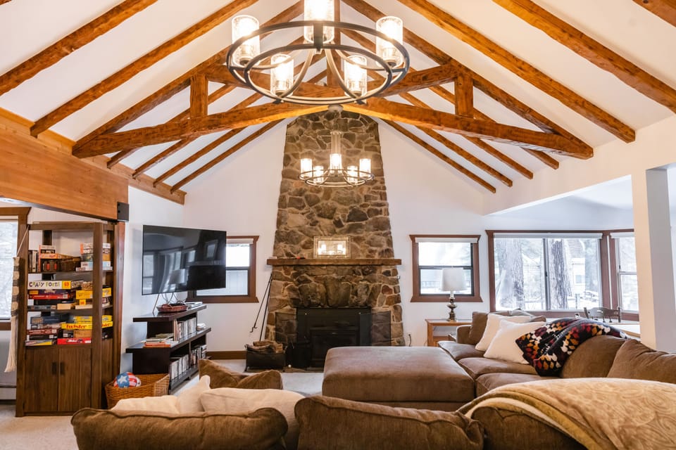 Large living room area with comfortable sectional, TV, fireplace, and games! 