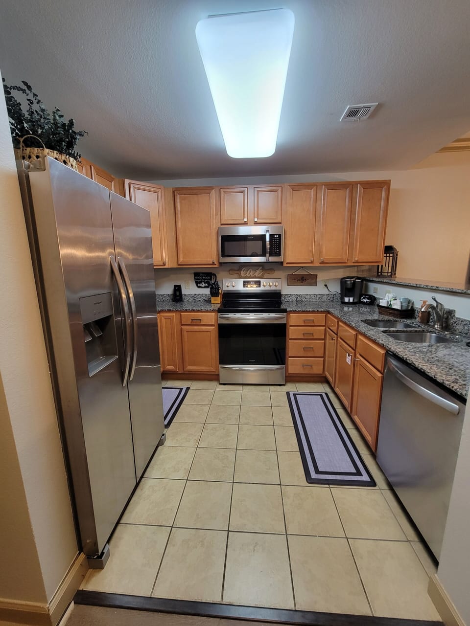 Kitchen features stainless steel appliances making meal prep a breeze.