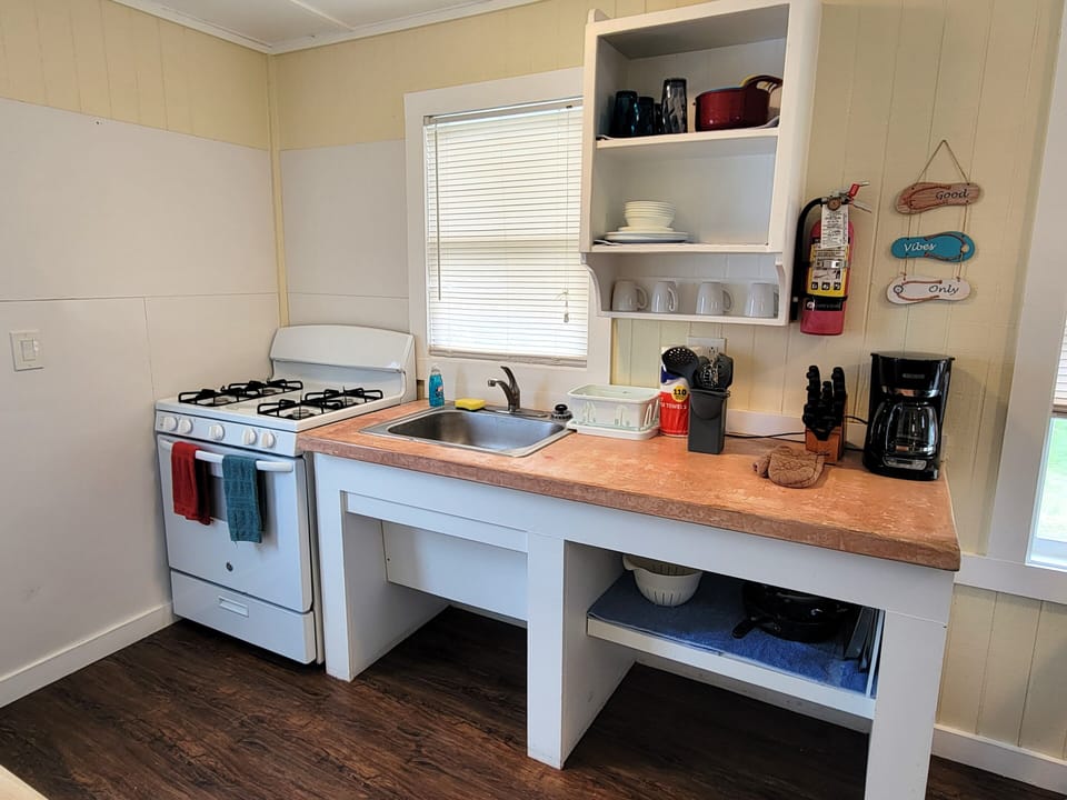 The kitchenette has a refrigerator, gas stove, microwave, and coffee maker.