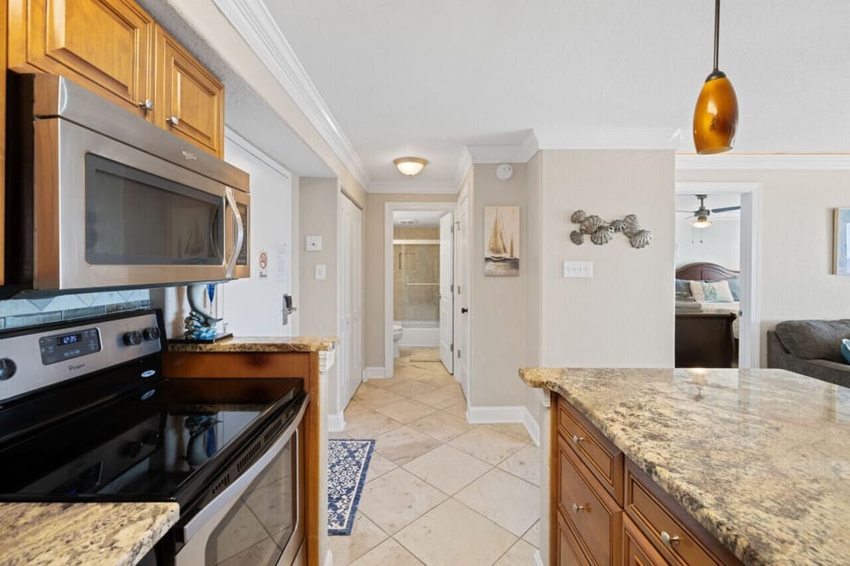 Coastal kitchen with granite counters and full-size appliances, easy cooking, quick snacks, and everything ready for your beach stay.