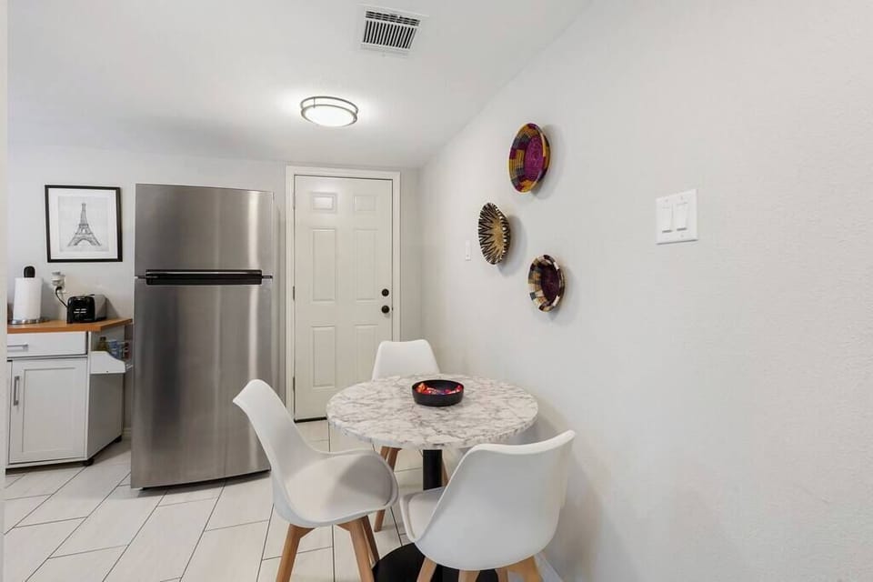 Kitchen equipped with Stainless Steel appliances and seating area.