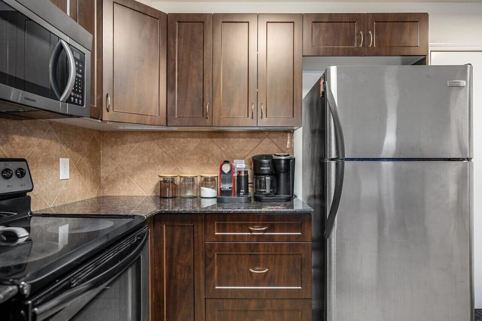 Full kitchen with an electric fondue set, air fryer, blender, crockpot/slow cooker, Keurig, Nespresso & drip coffee machines, ground coffee, tea, sugar and basic condiments (ketchup, mustard and relish.)
