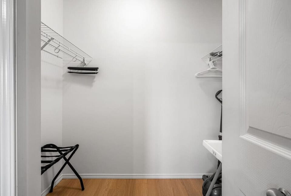 Primary bedroom with a king bed, dedicated workstation, Smart TV, blackout blinds, closet and private ensuite.