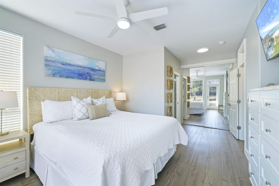 Oversized primary bedroom with en-suite bath offers King bed, Roku Smart TV, and front porch access.
