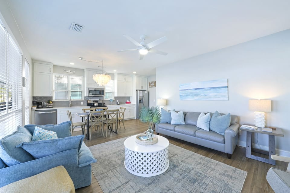 Living area with 55" Roku Smart TV and ample seating overlooks serene Four Prong Lake.