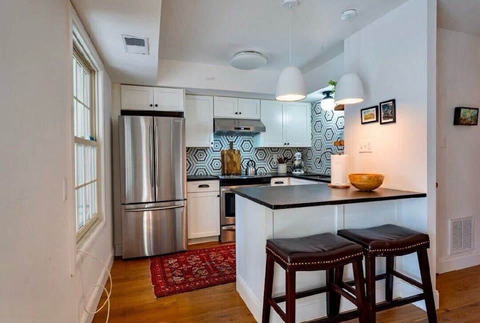 Kitchen with lots of counter space and seating at the bar.