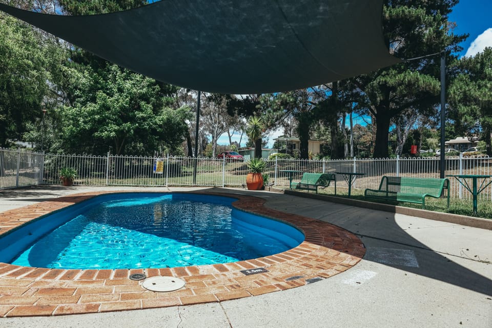Seasonal outdoor pool, open 8:00 AM to 6:00 PM, pool umbrellas