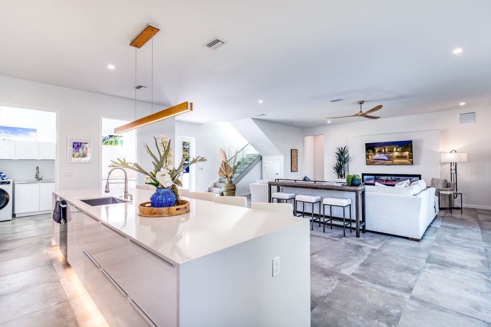Prep, pour, and gather at the sleek kitchen island, seamlessly connected to the living room.
