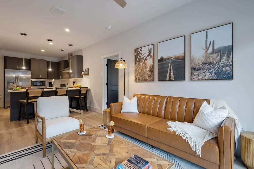 2nd Unit: Bright living room with comfortable seating, smart TV, designer decor, and access to the outdoor patio.