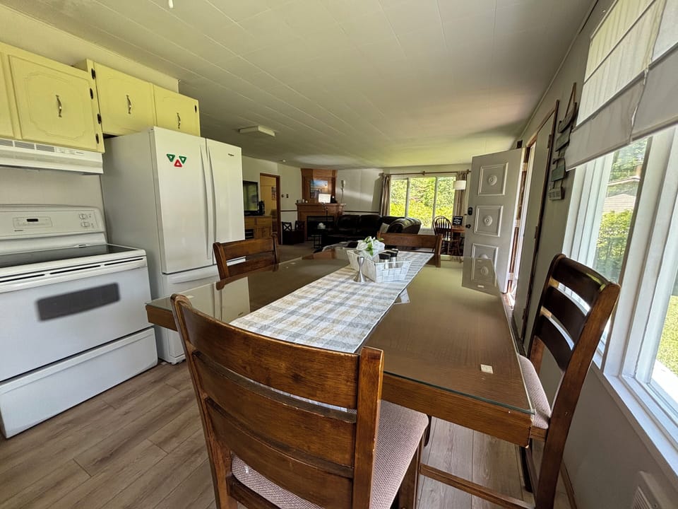 A wooden dining table set for four, adjacent to the living area.