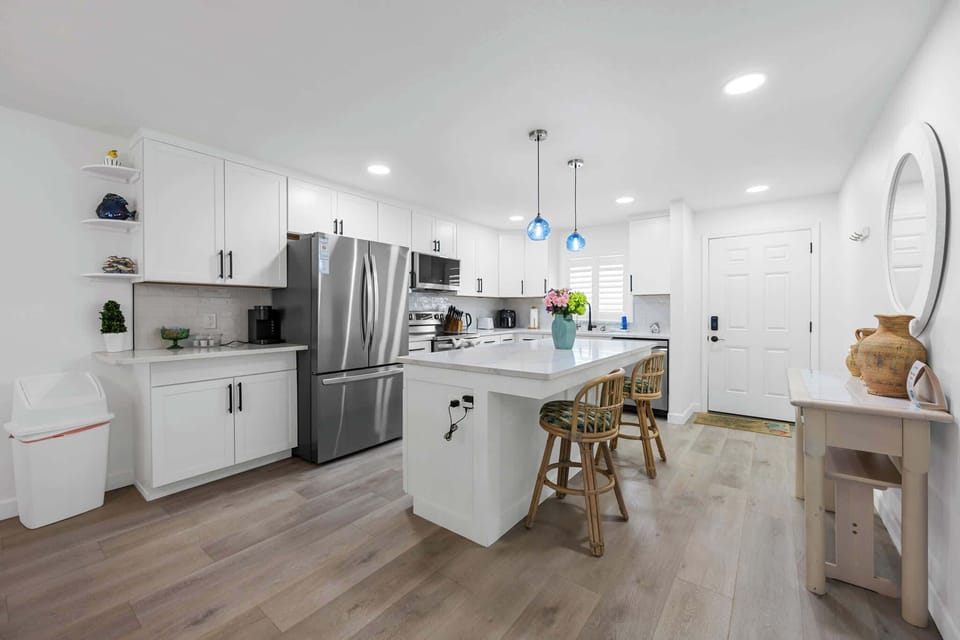 Modern kitchen with stainless steel appliances and a large island with seating.