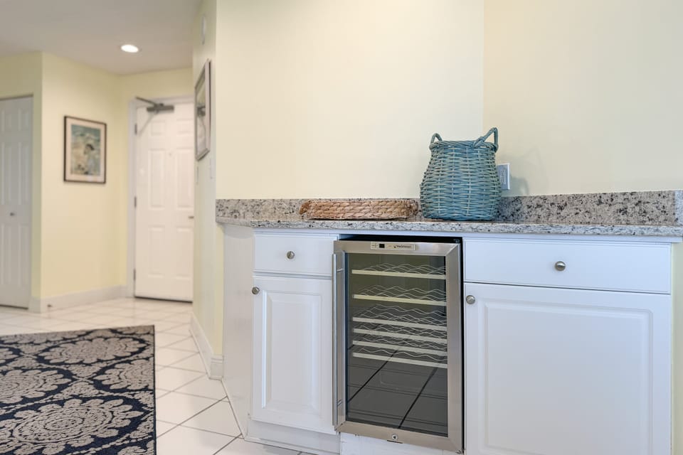 Enjoy effortless entertaining with this well-appointed dining area and wet bar. The integrated wine cooler and blender provide added convenience, while the contemporary design enhances the overall aesthetic.