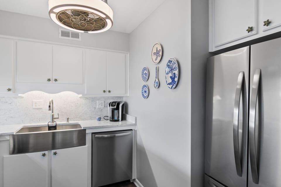Your fully-equipped kitchen features stainless steel appliances and elegant white cabinetry, perfect for preparing meals during your stay.