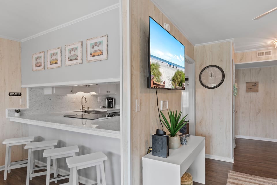 Your bright, coastal-inspired space features a modern kitchen with breakfast bar and entertainment area perfect for relaxing evenings.