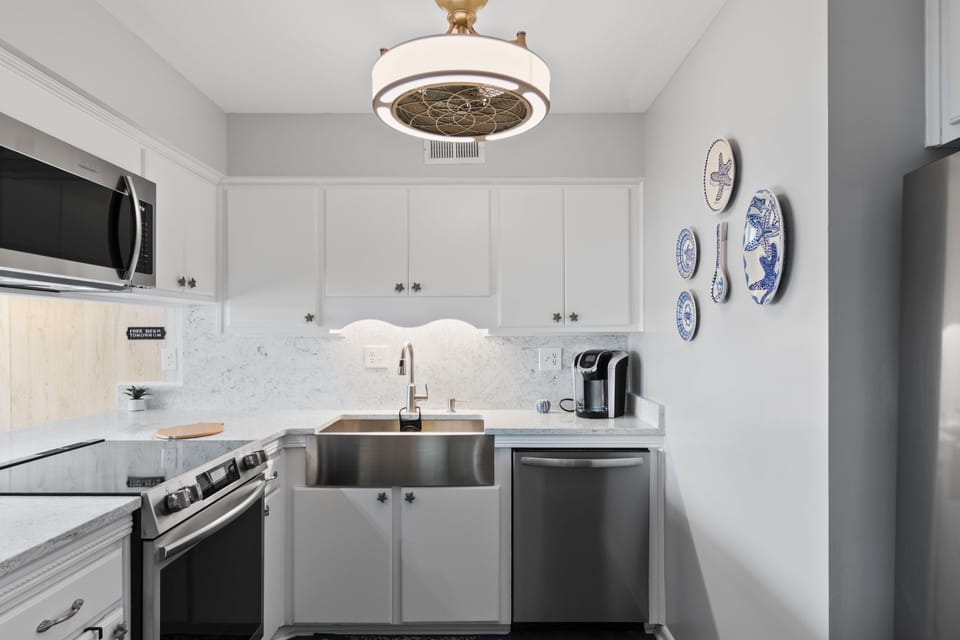 Your stylish galley kitchen features stainless appliances, marble counters, and thoughtful touches for all your culinary needs.