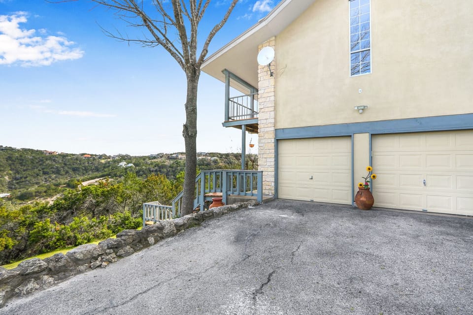 The Room with a View entrance is on the lower level deck to the left of parking
