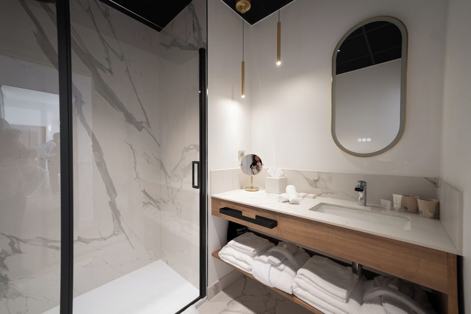 Suite, City View | Bathroom | Rainfall showerhead, hair dryer, bathrobes, towels