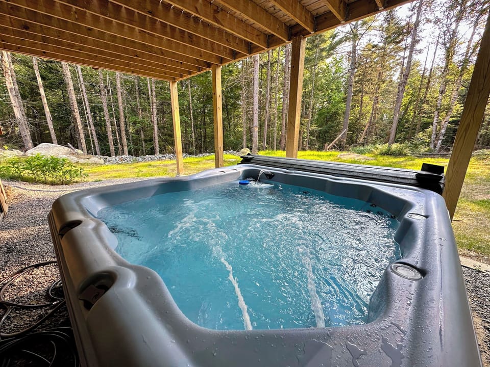 After a day of exploring, return to the cozy cabin and relax in the outdoor hot tub, surrounded by nature.