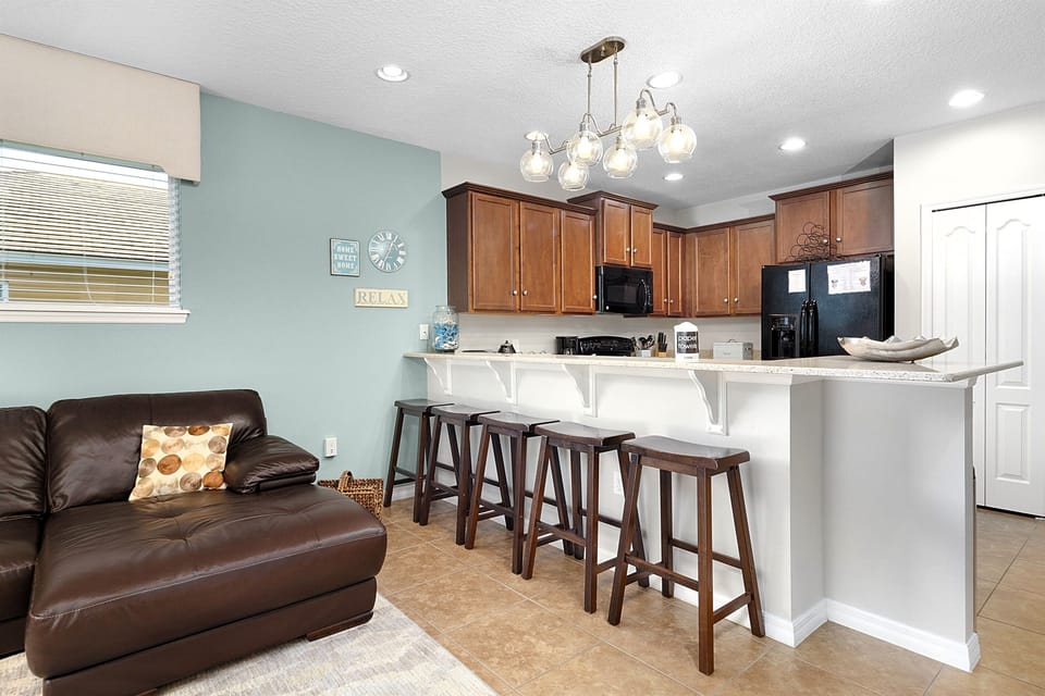 The kitchen counter has seating for five. 