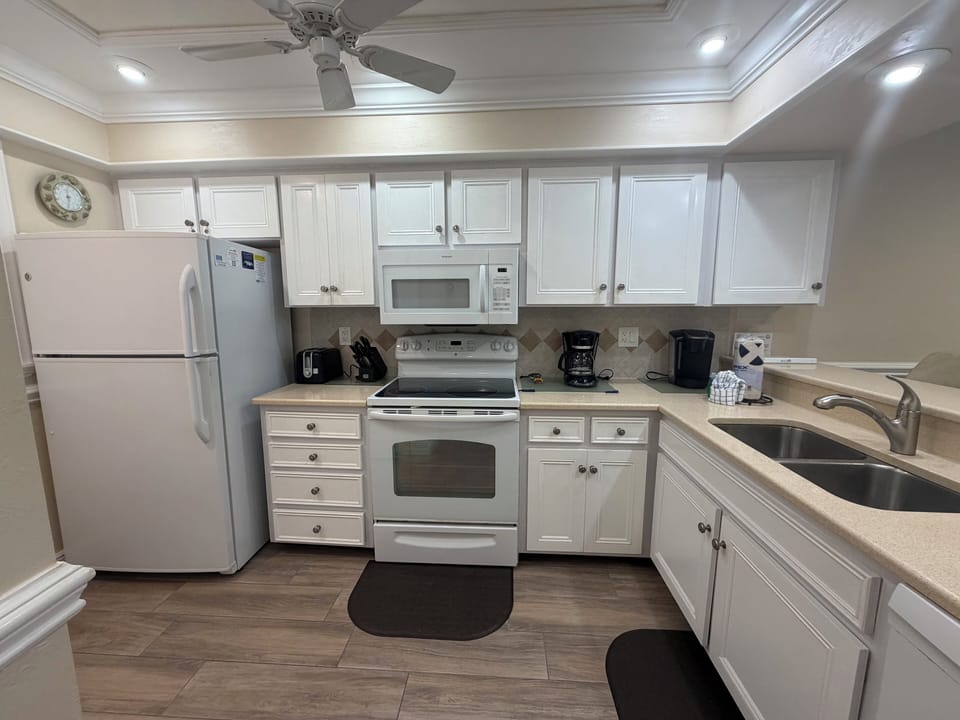 Your fully equipped kitchen features white cabinetry, full-size appliances, and everything you need to prepare home-cooked meals during your stay.