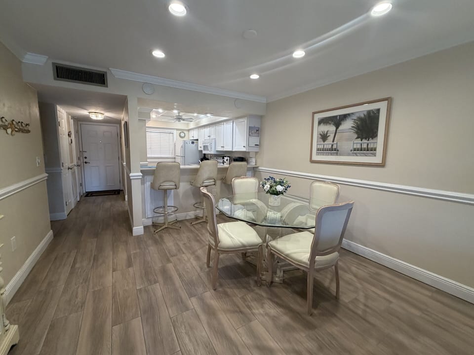 Your elegant dining space flows seamlessly into a bright kitchen, creating the perfect setting for memorable meals and relaxed conversations.