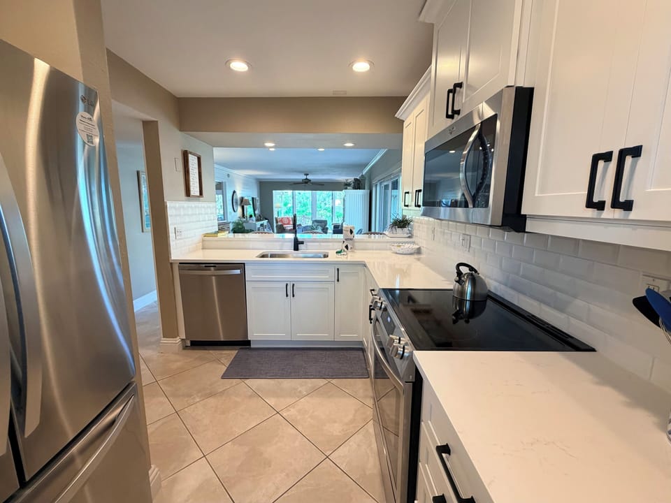Step into your bright, spacious kitchen with gleaming countertops, modern appliances, and an open flow that makes cooking feel effortless—ready for your favorite meals and morning coffee.