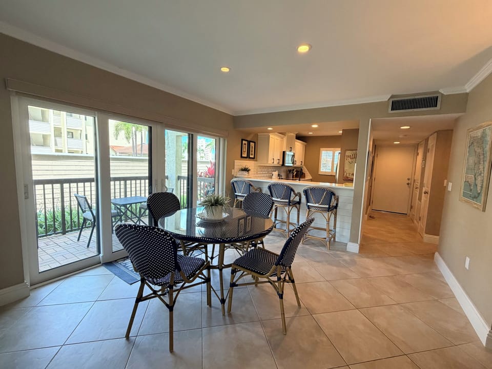 Gather around this inviting dining space with patio access, where your meals are bathed in natural light and open to a well-appointed kitchen—perfect for morning coffee or evening conversations.