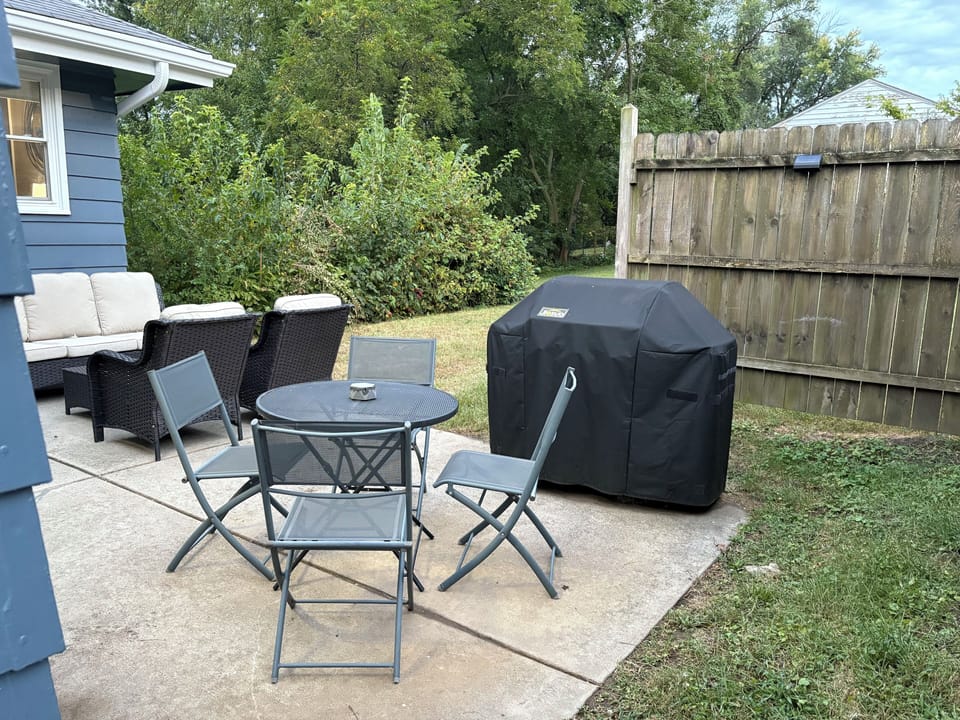Bistro table and chairs plus a Weber grill.