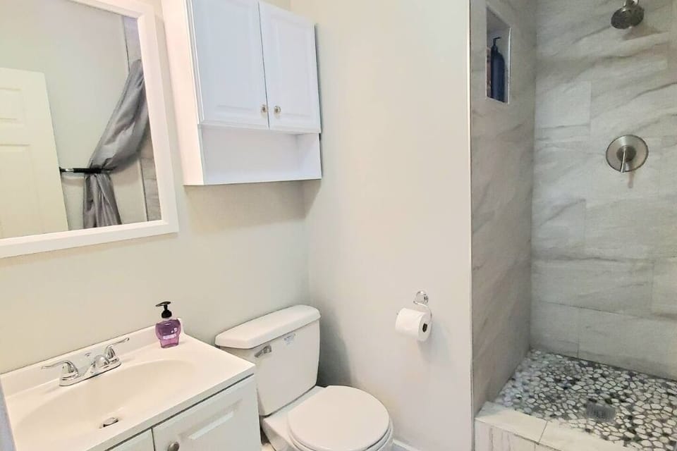 The loft features a well-appointed bathroom, designed to provide guests with modern comforts and a refreshing atmosphere for their convenience.