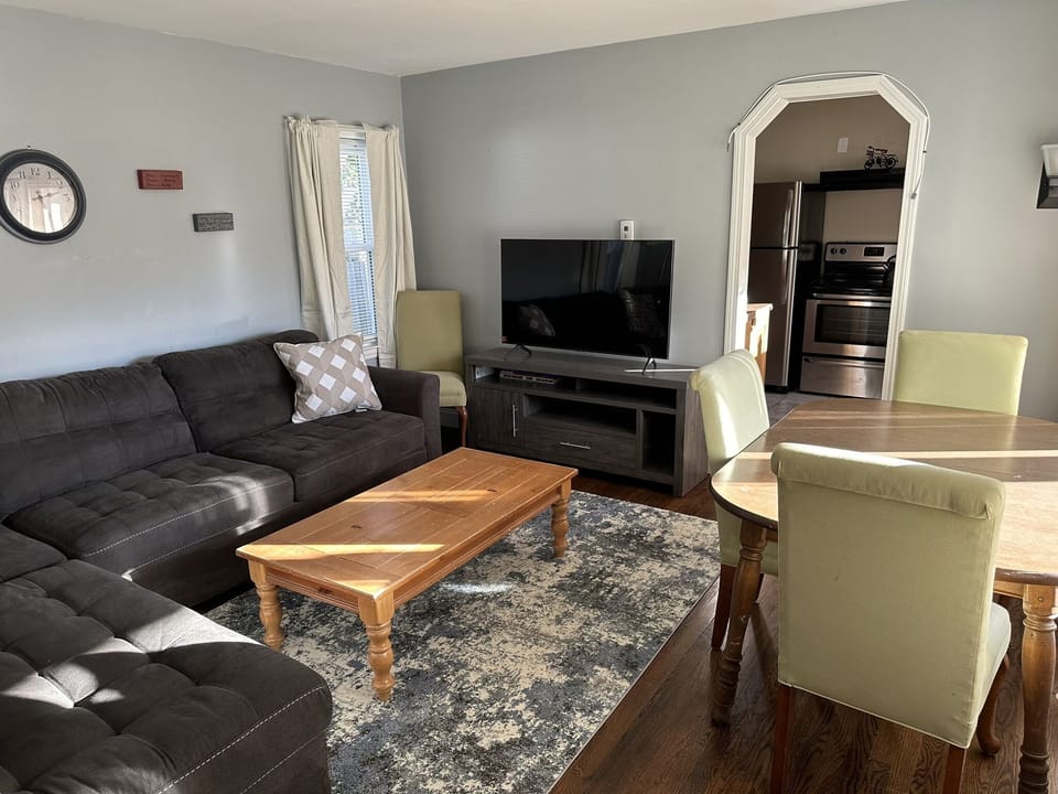 Cozy living room with dining table on right.