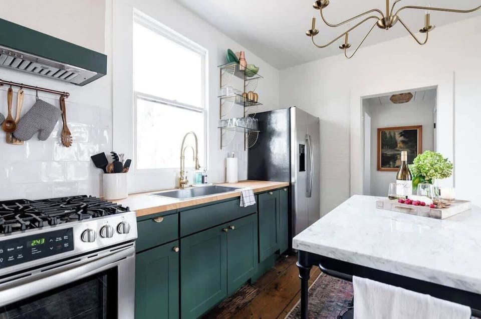 Fully-stocked kitchen with professional gas stove and large farmhouse sink.