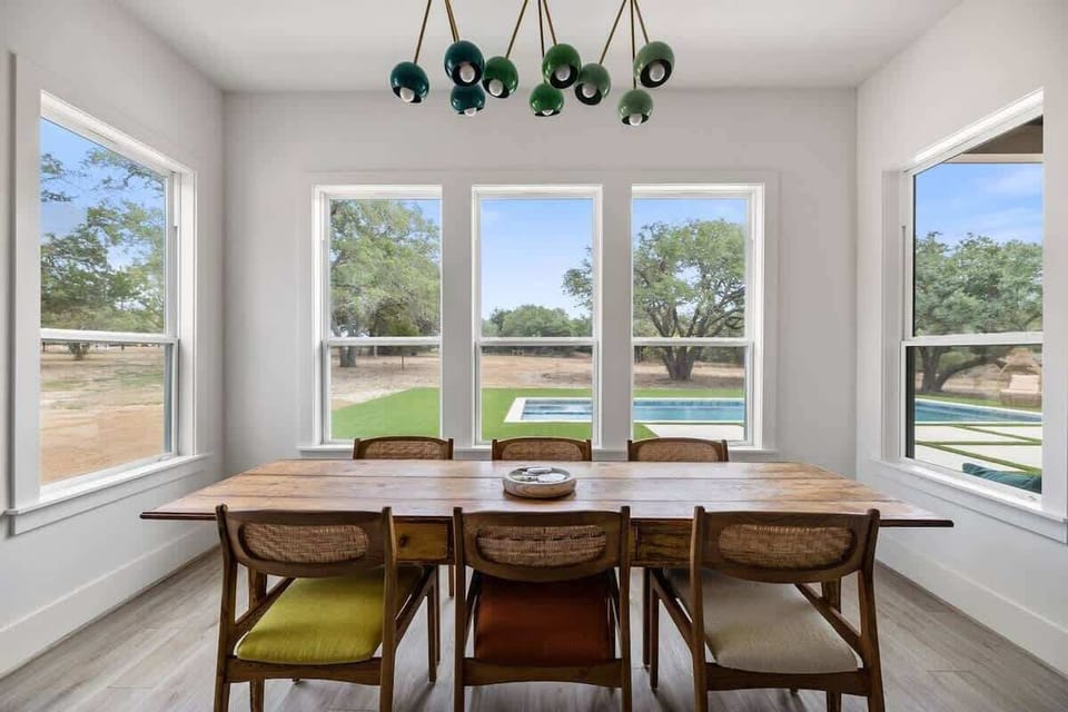 Dining table has room for 6-8 guests with additional seating for 4 at the kitchen island. 