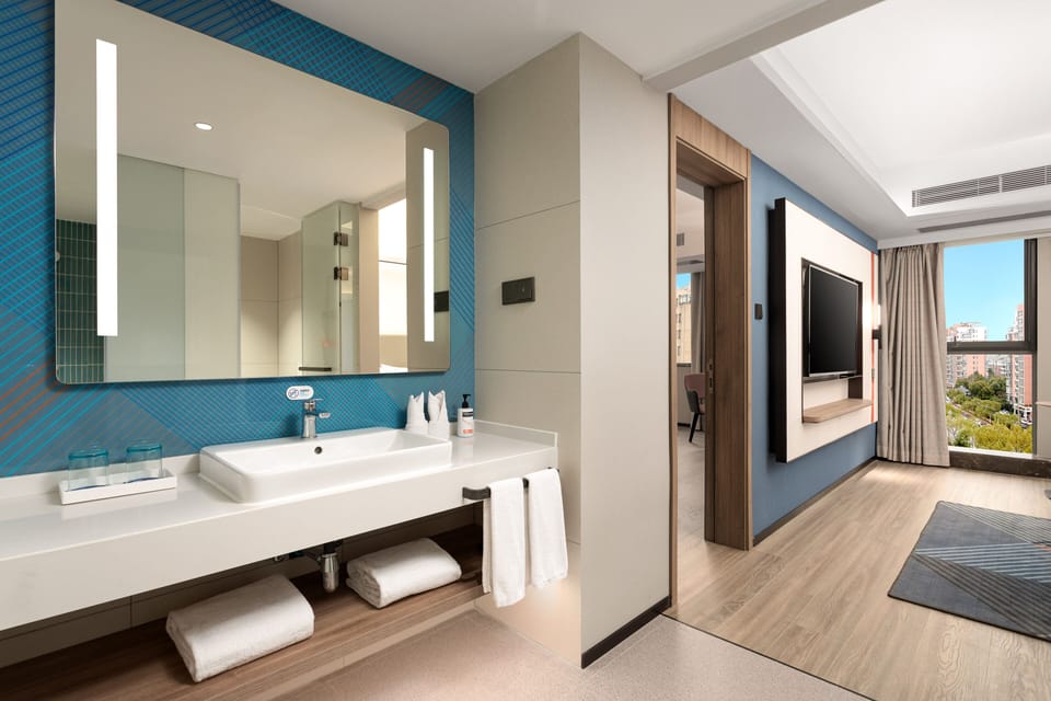 1 King 1 Bedroom Suite | Bathroom | Shower, free toiletries, hair dryer, slippers