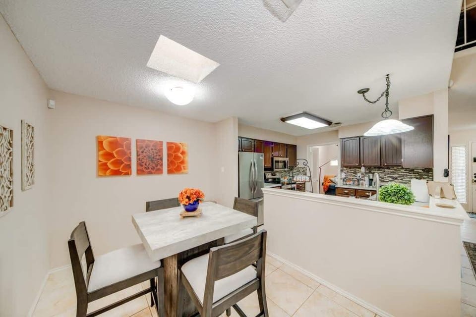 Bright and modern dining area with comfortable seating for four, perfect for enjoying meals together just steps from the kitchen.