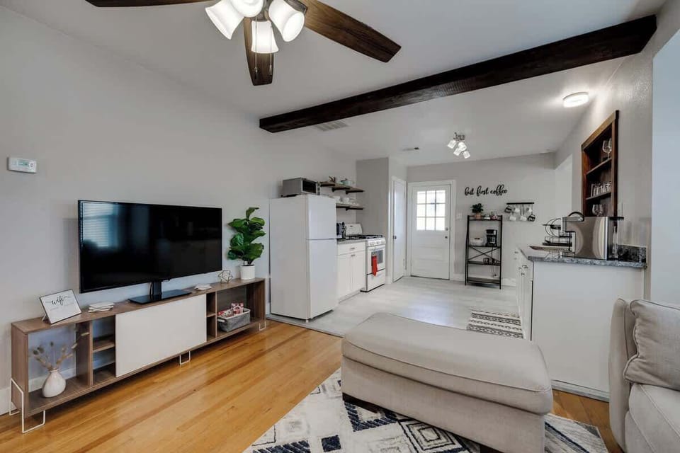Open living space with a flat-screen TV and easy flow into the kitchen for a seamless stay