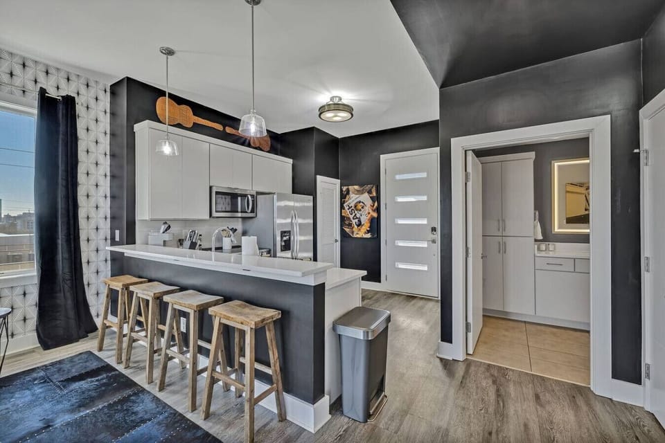 Entryway & Kitchen with stainless steel appliances and everything you`d need to make a home cooked meal