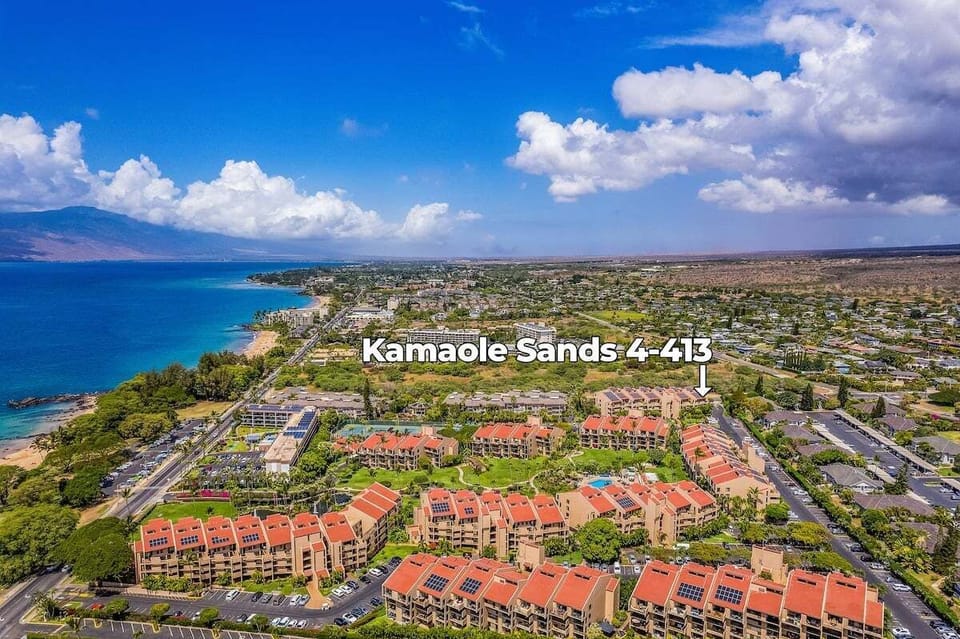 Stunning aerial view of the resort community showcasing pools, tropical landscaping, and vibrant island surroundings.