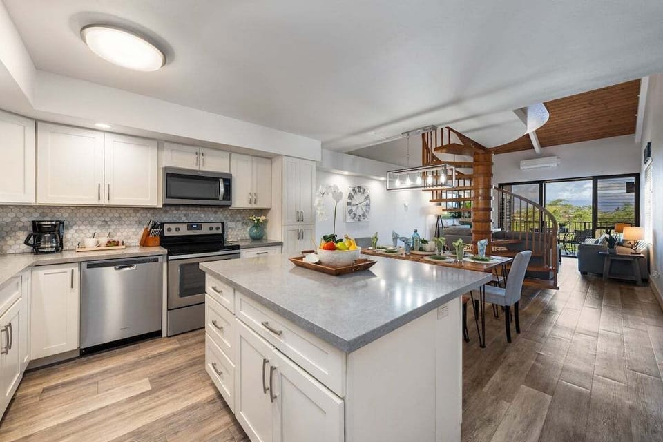 Modern kitchen with stainless‑steel appliances, sleek countertops, and seamless flow into the dining and living areas.
