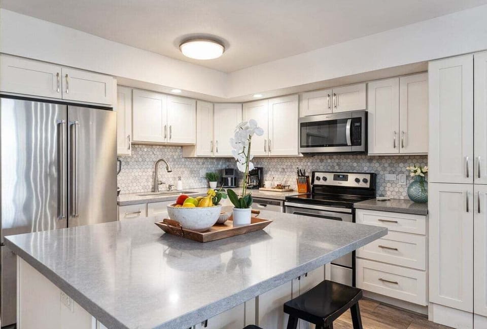 Fully equipped modern kitchen with stainless‑steel appliances, sleek countertops, and bright lighting for effortless vacation cooking.
