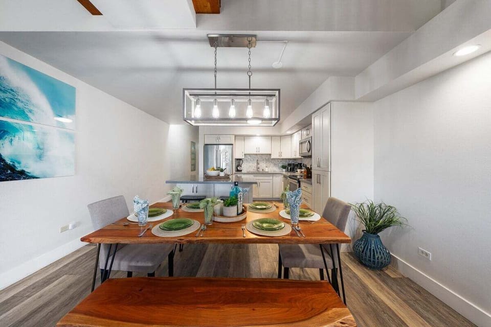 Beautifully staged dining table with place settings, greenery accents, and warm lighting for an inviting, home‑style dining experience.