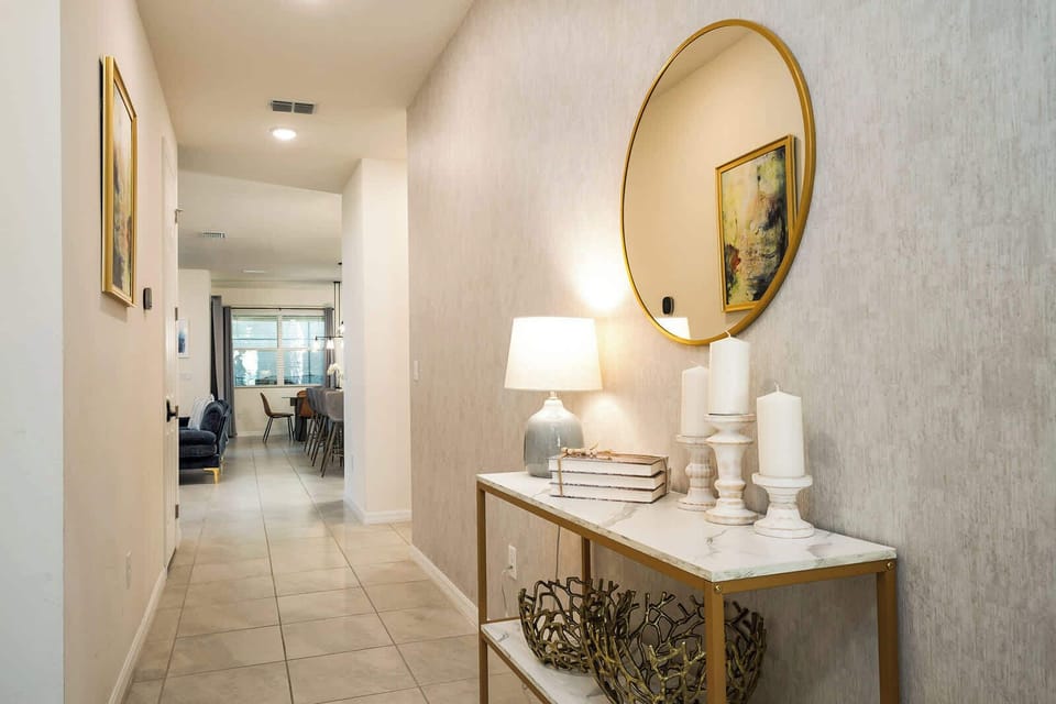 Inviting hallway with elegant decor leading to a cozy dining area, perfect for family gatherings.