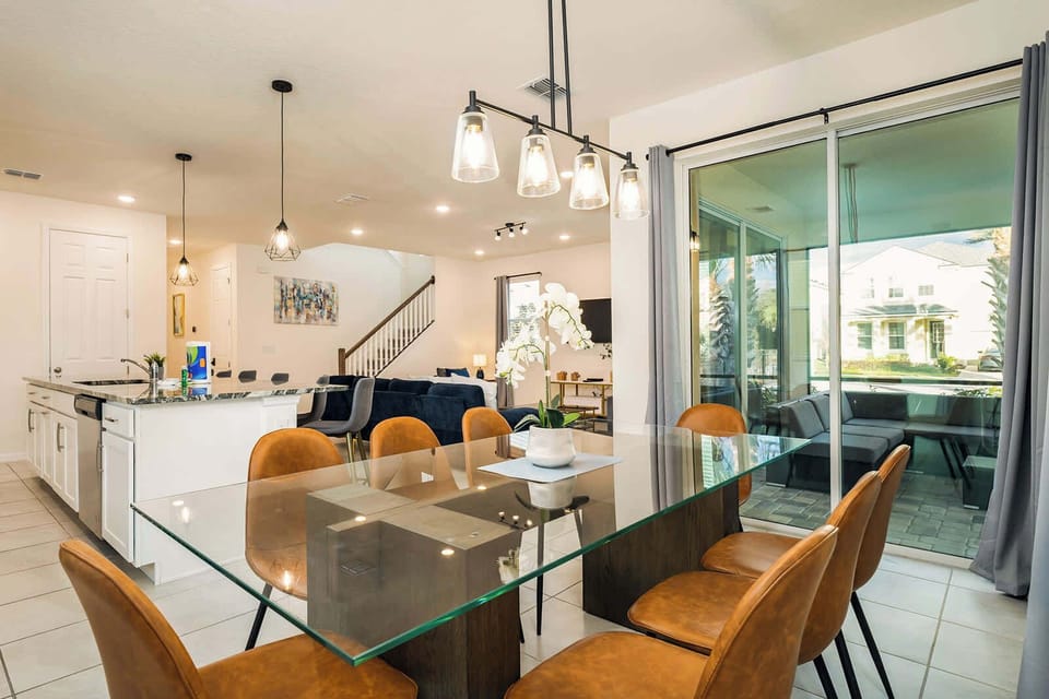 Elegant dining area with seating for eight, perfect for family gatherings, opening to a cozy outdoor patio.
