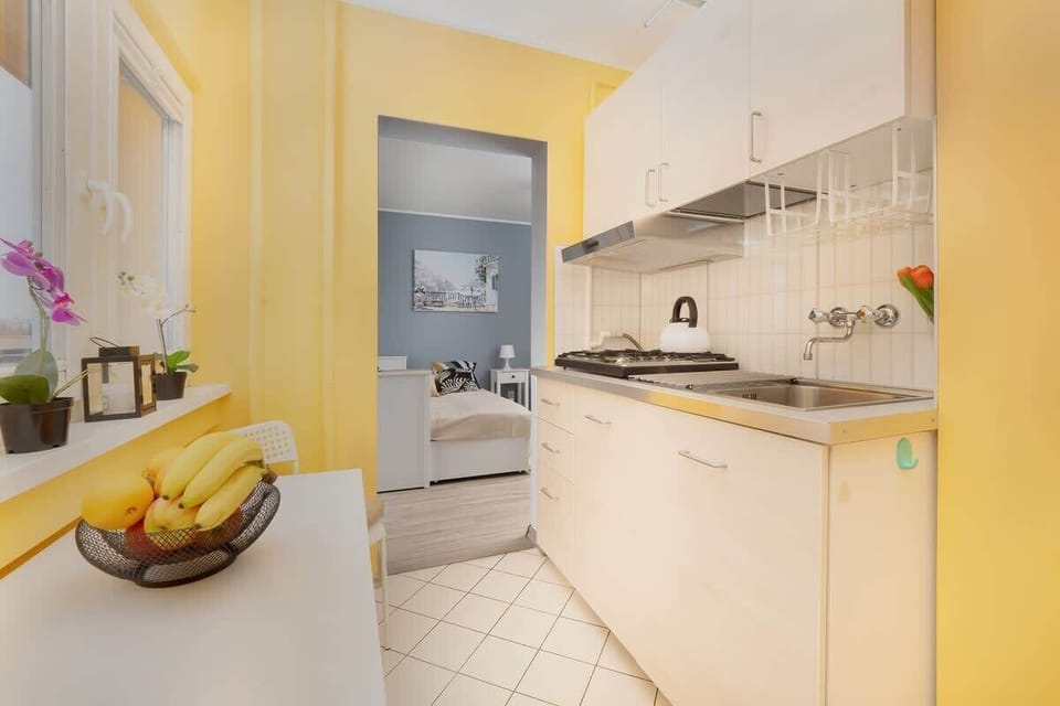Another angle of the kitchen, capturing its practical layout, light-colored cabinets, and bright, welcoming atmosphere.


