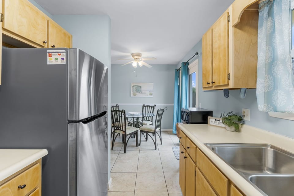 kitchen with stainless steel appliances and a dining area with natural light