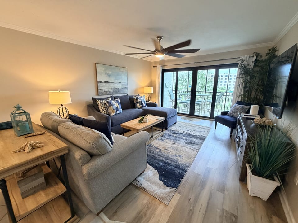 Sink into plush seating and unwind in your light-filled living space with coastal charm and a private balcony awaiting you.