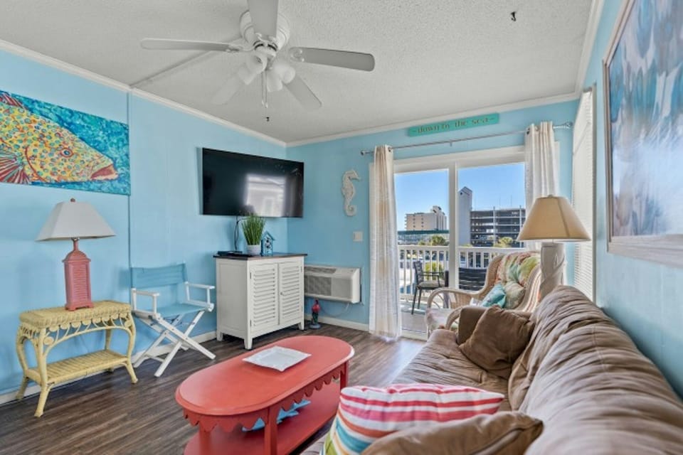 The private balcony off the living room invites you to step outdoors.