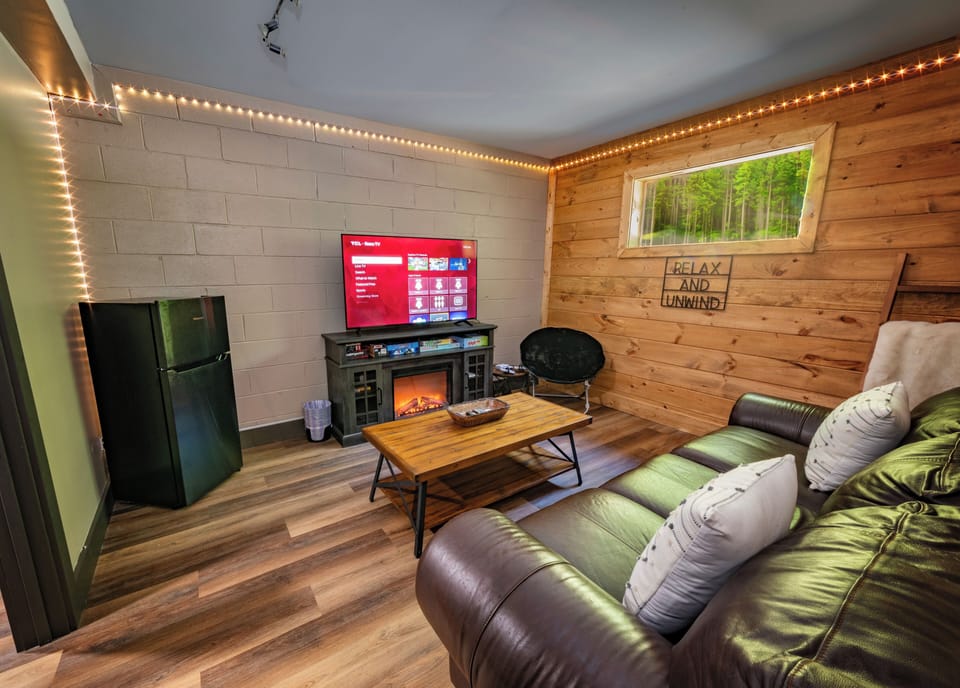 Game room with LED lights, fireplace feature, Nintendo console, and mini fridge❤️