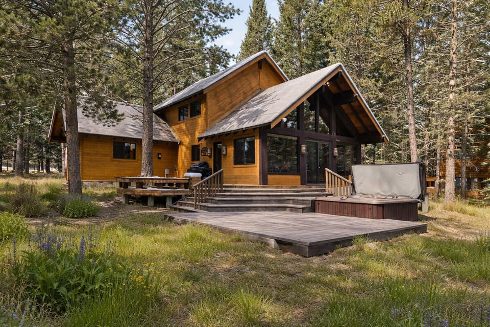 Unwind on the spacious back deck surrounded by tall pines and mountain grasses. Soak in the private hot tub, gather around the picnic table, or relax after a day exploring Yellowstone—your peaceful mountain retreat awaits.